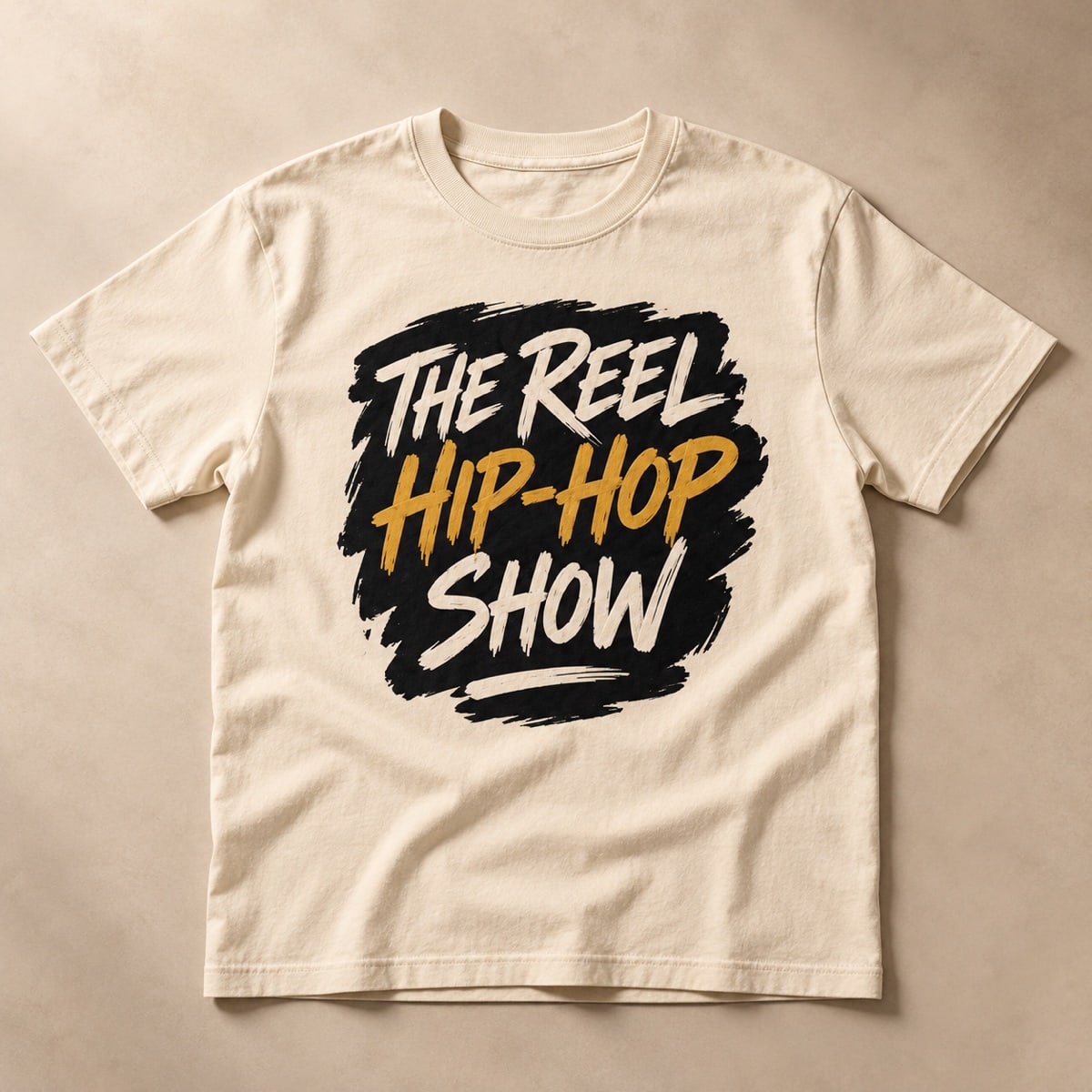Original concept cream T-shirt with The Reel Hip Hop Show brush lettering in black, ivory and gold